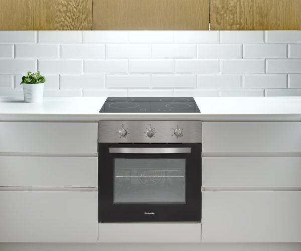 Design kitchen in a modern style with gray walls and white lockers and shelves. There is a glowing wooden kitchen hood, stove, oven, sink, fridge, wooden table with a chair, plant in the pot, lamps.